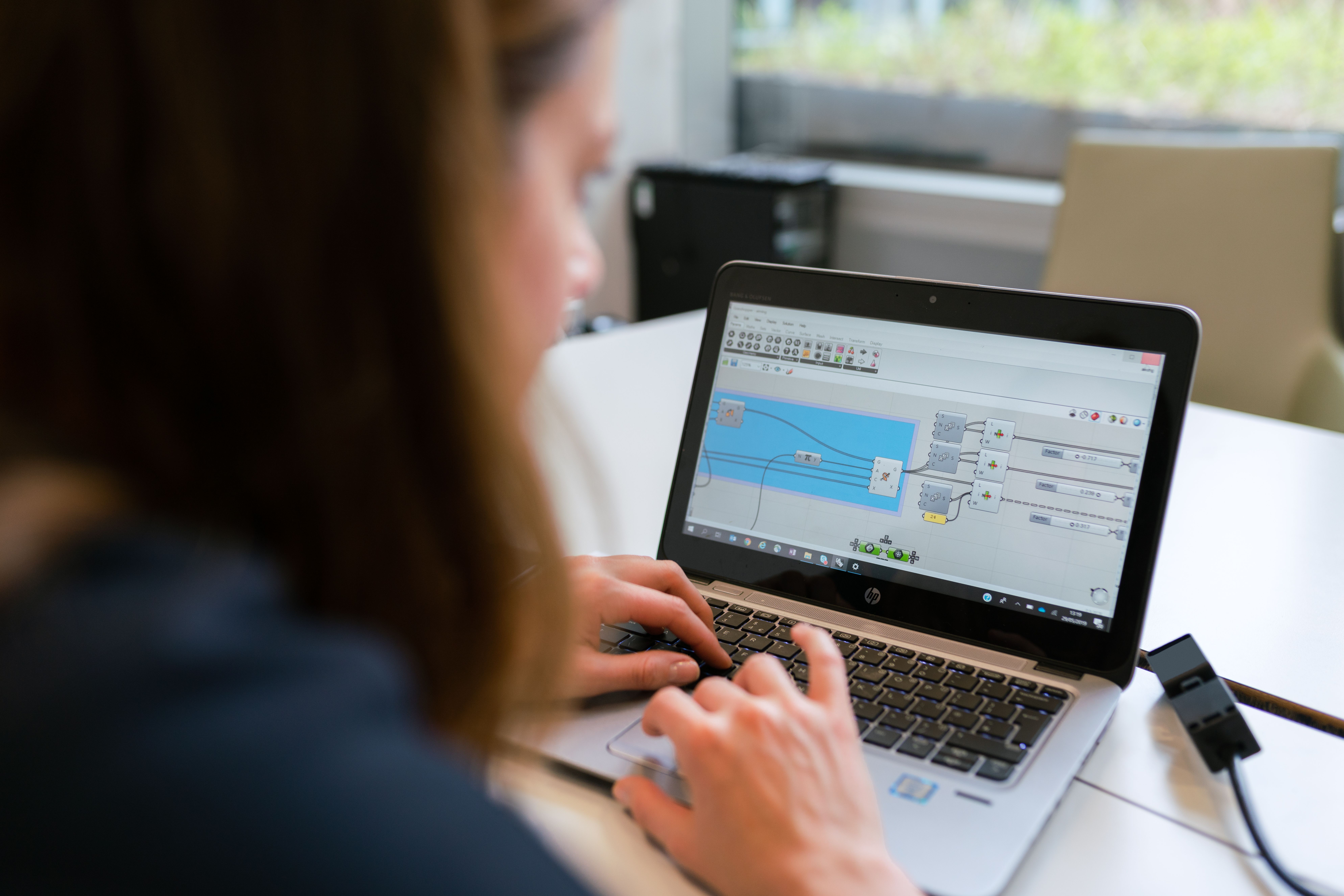 Una mujer profesional analizando software en un ordenador portátil en un entorno de oficina moderno. Una mujer profesional analizando software en un ordenador portátil en un entorno de oficina moderno.