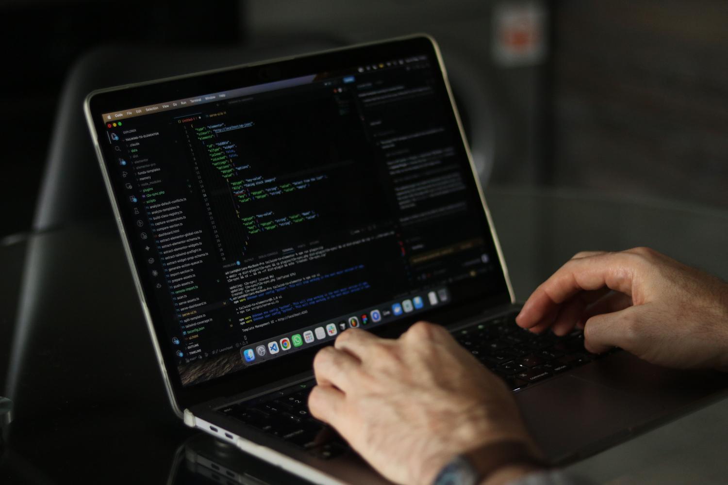 Primer plano de unas manos programando en un ordenador portátil, representando la productividad y la creación de scripts.
