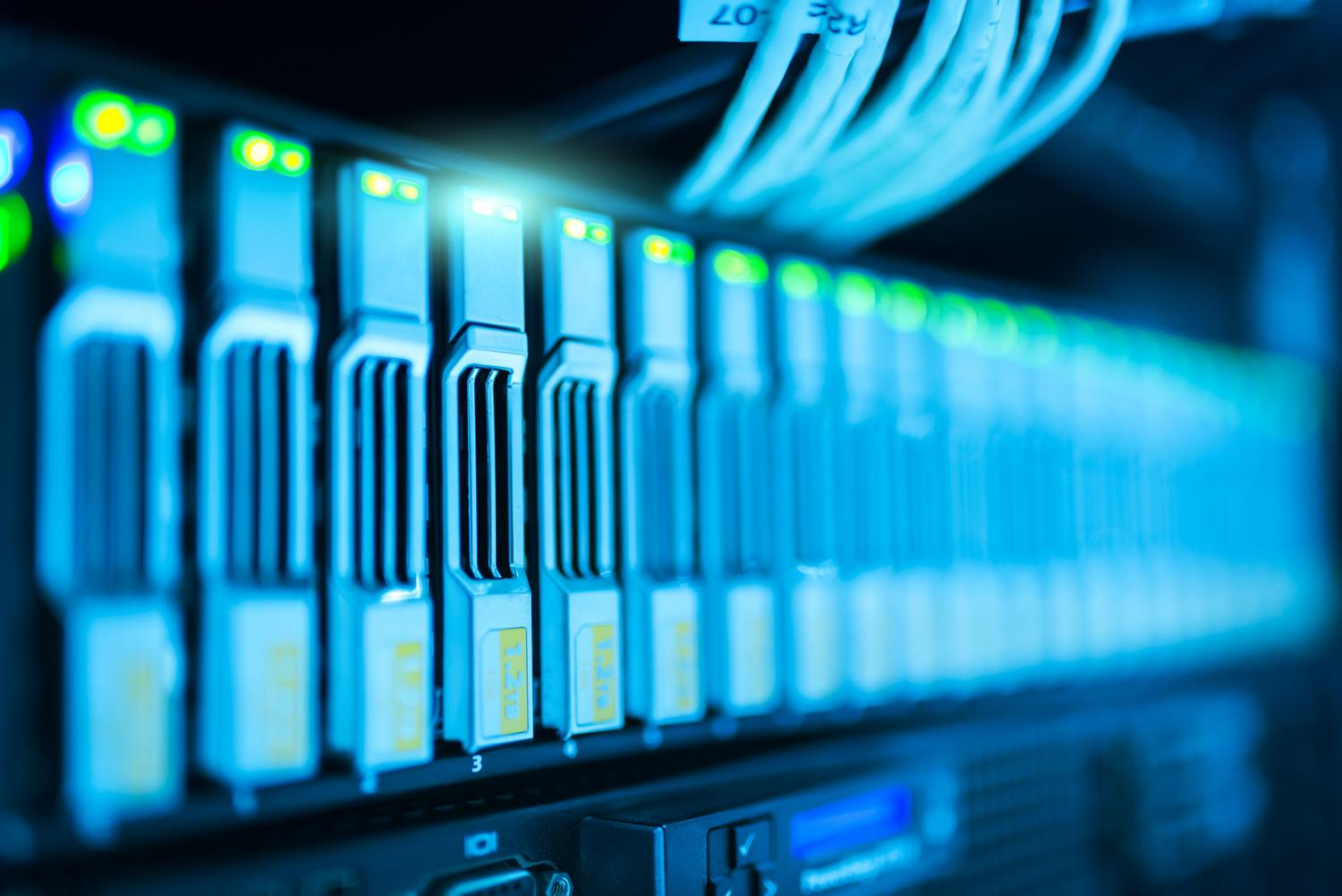 Primer plano de un rack de servidores con luces brillantes en un centro de datos moderno, representando la infraestructura física.